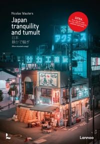 Book cover of Japan: Tranquility and Tumult, with blue neon lights above Japanese cityscape. Published by Lannoo Publishers.