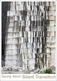 Wall of stone blocks, brick pile below, on white cover, Georg Aerni Silent Transition in beige font below