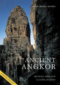 Tower covered in carved faces of Bayon Temple at Angkor Thom, on cover of 'Ancient Angkor', by River Books.