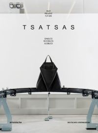 Large black leather bag on metal conveyer belt, on white cover, 'TSATSAS, past present future', by Arnoldsche Art Publishers.