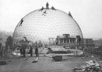 Walther Bauersfeld's geodesic dome with men on top on landscape cover of 'TECHNOSCAPE, The Architecture of Engineers', by Forma Edizioni.