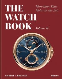 IWC Schaffhausen Yacht Club wristwatch, new moon and tide complication, on dark blue face, gold surround, on red cover, THE WATCH BOOK in white font above.