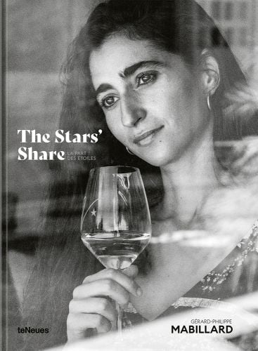 Long haired brunette woman, holding glass of wine, gazing through window, The Stars’ Share LA PART DES ÉTOILES, in white font to left of centre.