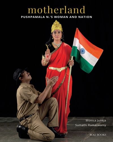 Artist Pushpamala N in Indian dress, holding Indian flag, during a photo performance, motherland, in gold font above.