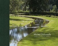 Green landscaped garden with curved lake, Michel Delvosalle Garden & Landscape Architect in white font to lower right.
