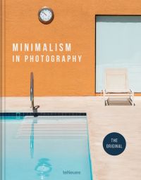 Corner of swimming pool, cream deck chair, orange wall with clock, Minimalism in Photography in white font