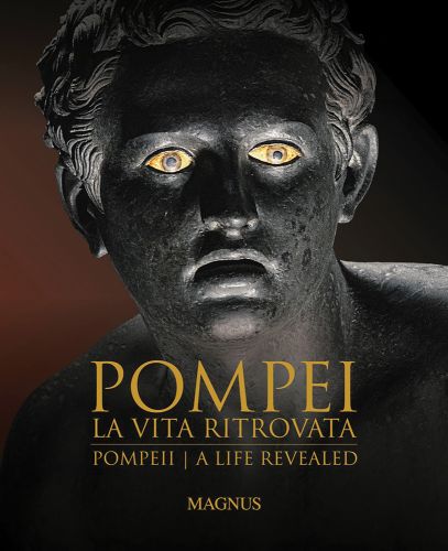 Bronze head with mouth open, bright yellowing eyes, on dark cover, POMPEII LA VITA RITROVATA in gold font below.
