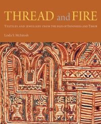 Decorative ancient textile in orange and cream, on cover of 'Thread and Fire, Textiles and Jewellery from the Isles of Indonesia and Timor', by River Books.