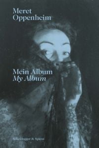 Meret Oppenheim peering through black lace, black cover, Meret Oppenheim Mein Album My Album in pale blue font.