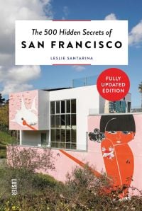 Pink mural on wall of Helipad House, lady with tattoo, finger on sharks eyeball, on cover of 'The 500 Hidden Secrets of San Francisco', by Luster Publihsing.