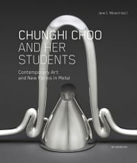Silver metalwork container with arched tubing above, on grey cover of 'Chunghi Choo and Her Students, Contemporary Art and New Forms in Metal' by Arnoldsche Art Publishers.