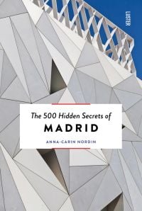 Modern white exterior of ABC Museum in Madrid, on cover of travel guide 'The 500 Hidden Secrets of Madrid', by Luster Publishing.