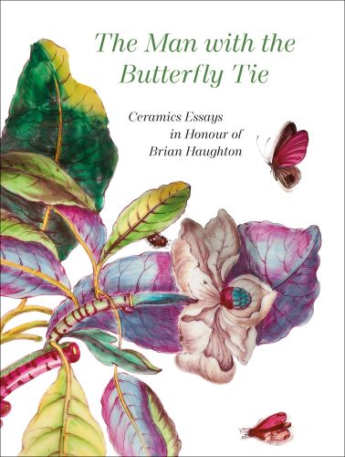 Painting of white flower shrub, pink butterflies hovering around, on white cover of 'The Man with the Butterfly Tie, Ceramics Essays in Honour of Brian Haughton', by Arnoldsche Art Publishers.