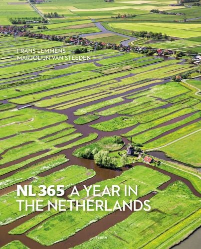 Aerial view of Oostzaan, Netherlands, with windmill, on cover of 'NL365- A Year in The Netherlands', by Lannoo Publishers.