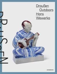 Book cover of 'Draußen Outdoors, Hans Wewerka, Stoneware Street Scenes / Straßenszenen in Steinzeug, with glazed ceramic figure of man cross-legged on floor, playing a guitar. Published by Arnoldsche Art Publishers.