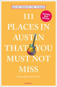 Rainbow colored electric guitar near center of peach cover of '111 Places in Austin That You Must Not Miss', by Emons Verlag.