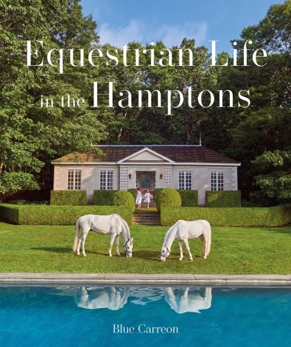 Two white horses grazing in front of single storey house, with topiary hedges, on cover of 'Equestrian Life in the Hamptons', by Images Publishing.