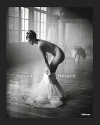 Nude white female model pulling on a white netted skirt, in studio space, Vincent Peters PERSONAL, in white font to lower left of centre cover.