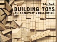 Wooden building blocks scored with grid lines, BUILDING TOYS AN ARCHITECT'S COLLECTION, in black font to upper right.