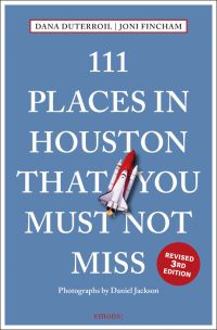 Space rocket near center of blue cover of '111 Places in Houston That You Must Not Miss', by Emons Verlag.