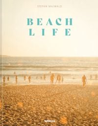 Beach landscape with people in the water, under a hazy sun, on cover of 'Beachlife', by teNeues Books.