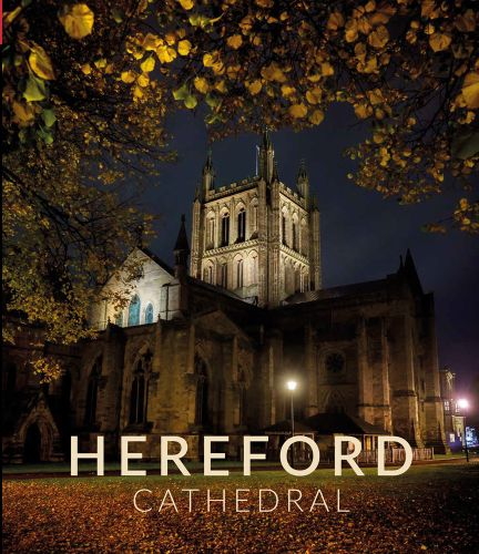 Hereford cathedral illuminated at night, on cover of 'Hereford Cathedral' souvenir guide, by Scala Arts & Heritage Publishers Ltd.