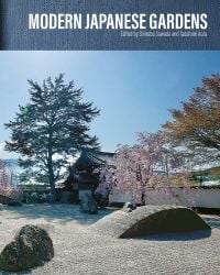 Japanese garden with stones, pink blossom tree and small bridge, on cover of 'Modern Japanese Gardens', by ACC Art Books.