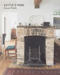 Interior of Kettle's Yard room with brick fire place, wood floor, on cover of 'Kettle's Yard House Guide', by Kettle's Yard, University of Cambridge.