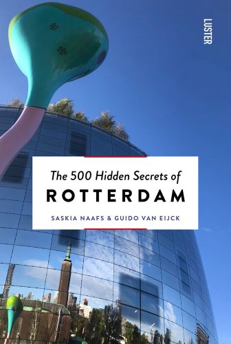 Tall sculpture in Rotterdam by artist Pipilotti Rist, 'The 500 Hidden Secrets of ROTTERDAM', in black font on white banner below.