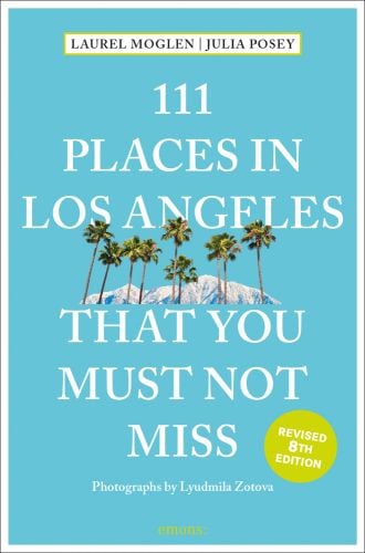 Row of palm trees with mountain behind, near center of turquoise cover of '111 Places in Los Angeles That You Must Not Miss', by Emons Verlag.