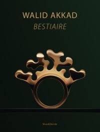 Close-up of gold elk ring, bearing four antlers, on cover of 'Walid Akkad, Bestiaire', by Silvana.