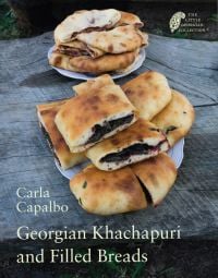 Two plates of food filled breads, 'Georgian Khachapuri and Filled Breads', in cream font below, by Pallas Athene.