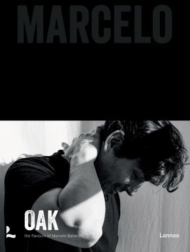 Michelin star Chef Marcelo Ballardin leaning forward with right hand on back of neck, on cover of 'Oak. Marcelo', by Lannoo Publishers.