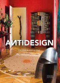 Interior living space with red walls, dark wood sculptures, on cover of 'Antidesign', by Editions Norma.