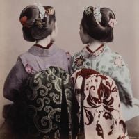 Book cover of Sebastian Dobson's Japan on a Glass Plate: The Adventure of Photography in Yokohama and Beyond, 1853–1912, with two Japanese figures in traditional dress, with their backs to the viewer. Published by Ludion.