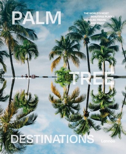 Idyllic travel location with palm trees bowing over water, on cover of 'Palm Tree Destinations, by Lannoo Publishers.