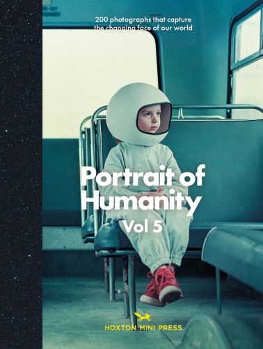 Young child in space suit and helmet, looking out the window of a bus, on cover of 'Portrait of Humanity Vol 5, 200 photographs that capture the changing face of our world', by Hoxton Mini Press.