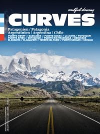 Straight road heading towards snowy mountain landscape in Patagonia, on cover of 'Curves: Patagonia', by Delius Klasing Verlag GmbH.