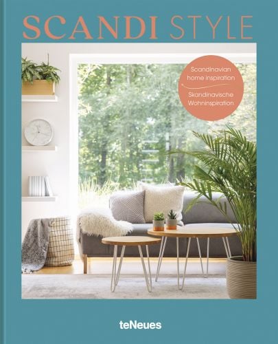 Calm interior with white and grey furnishings, coffee-table, forest outside, on cover of 'Scandi Style, Scandinavian Home Inspiration', by teNeues.