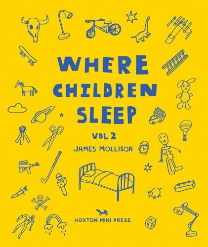 Metal framed bed surrounded by children's toys, on yellow cover of 'Where Children Sleep Vol. 2', by Hoxton Mini Press.