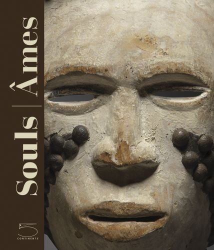 Pale African mask with brown raised spots on cheeks, on cover of 'Souls, Masks from Leinuo Zhang African Art Collection', by 5 Continents Editions'.