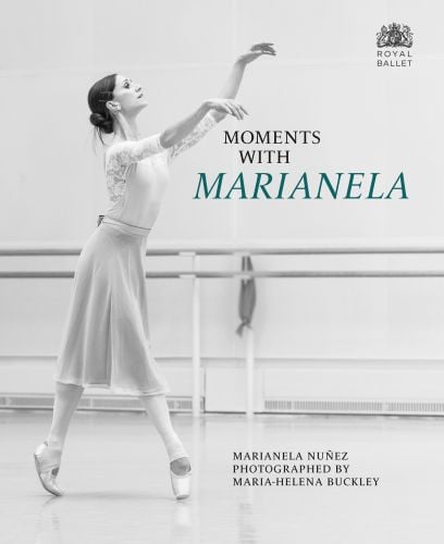 Ballerina on tip-toe, holding up arms, barre behind, on cover of 'Moments with Marianela', by Scala Arts & Heritage Publishers.