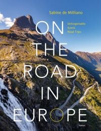 Book cover of Sabine de Milliano's, On the Road in Europe: Unforgettable Scenic Road Trips, featuring a mountainous landscape with waterfall, and winding roads below. Published by Lannoo Publishers.