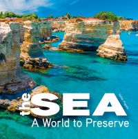 Salento beach area with bright blue water and rocky coast, on cover of 'The Sea, A World to Preserve', by White Star.