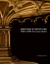 Underneath of gothic style carved table with single centre leg, on black cover of 'British Furniture 1820 to 1920', by ACC Art Books.