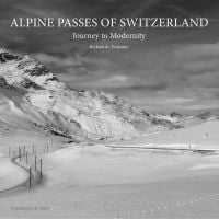 Snow covered landscape with mountain range and winding road, on cover of 'Alpine Passes of Switzerland, Journey to Modernity', by Scheidegger & Spiess.