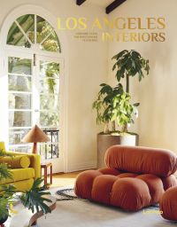 Interior living room with a bulbous terracotta armchair, large pot plant in corner, arched doors looking out into garden, on cover of 'Los Angeles Interiors', by Lannoo Publishers.