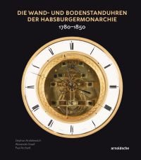 White lock face with gold mechanism, on black cover of 'Die Wand- und Bodenstanduhren der Habsburgermonarchie, 1780–1850', by Arnoldsche Art Publishers.