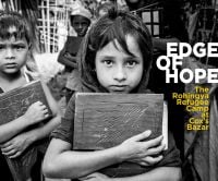 Group of children holding books, staring at viewer, on cover of 'Edge of Hope, The Rohingya Refugee Camp at Cox's Bazar', by Pallas Athene.