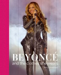 Beyoncé performing on stage in a silver mirrored dress, on cover of 'Beyoncé, and the clothes she wears', by ACC Art Books.